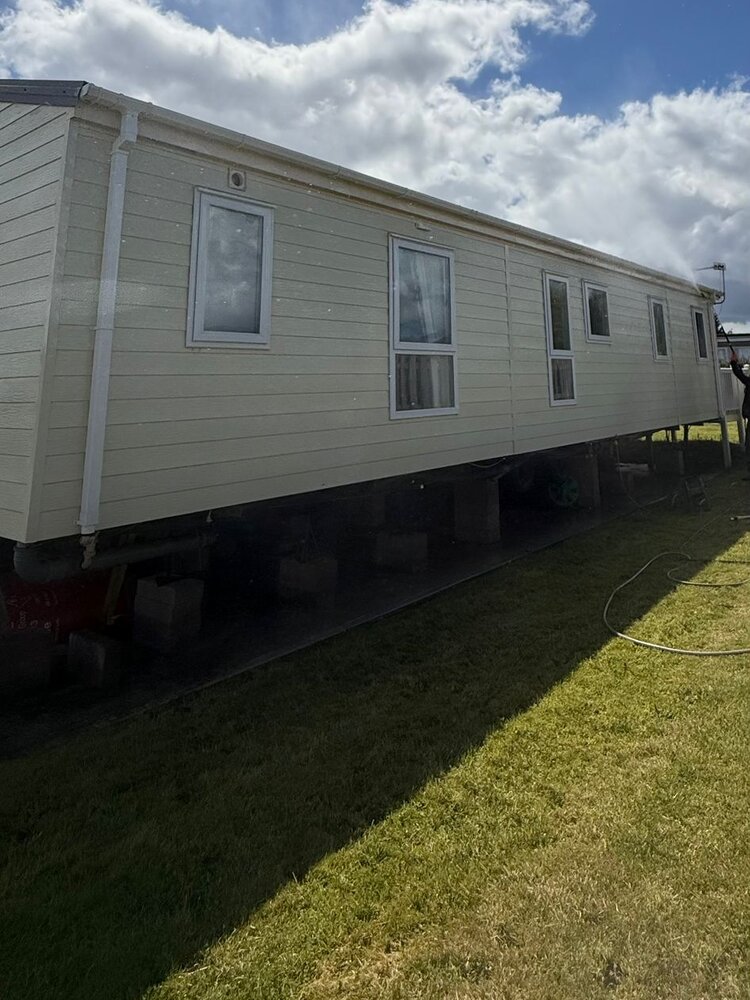 A static caravan exterior washed back to bright cream after cleaning