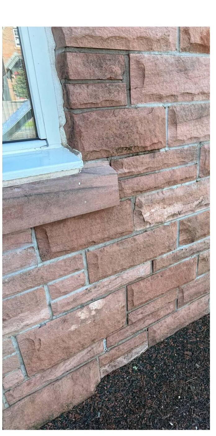 Restored pink sandstone wall after soft washing