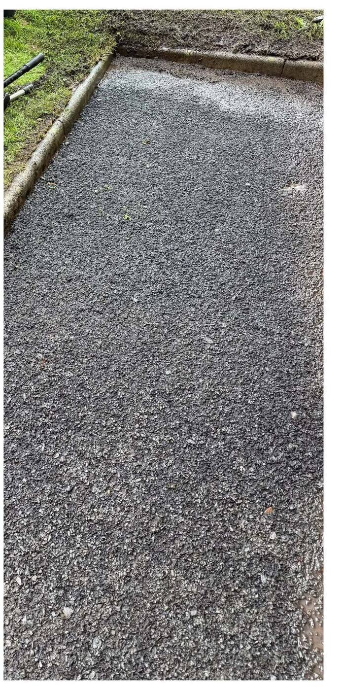 The same tarmac driveway restored to a clean dark finish