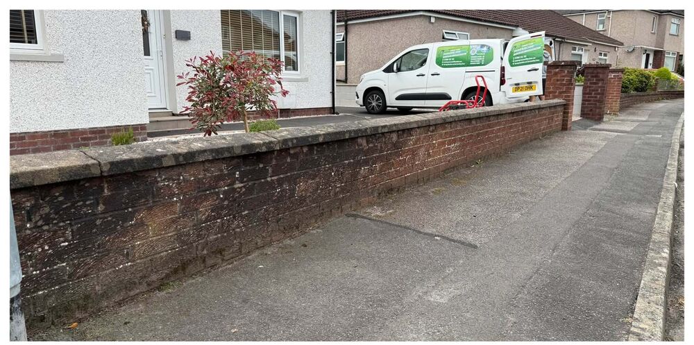 Grimy garden wall with the Take The Pressure Off Ltd van parked alongside
